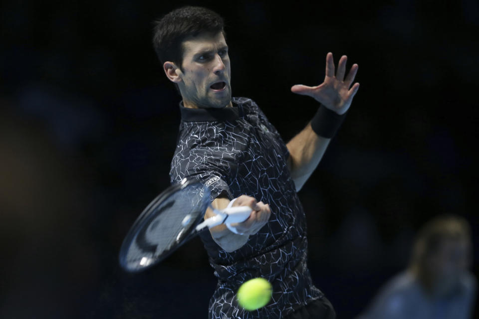Novak Djokovic of Serbia plays a return to Kevin Anderson of South Africa in their ATP World Tour Finals singles tennis match at the O2 Arena in London, Saturday Nov. 17, 2018. (AP Photo/Tim Ireland)