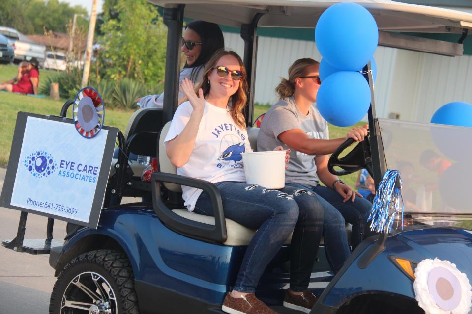 Eye Care Associates employees wave to the crowd lining Willis Avenue during the Perry homecoming parade on Wednesday, Sept. 14, 2022.