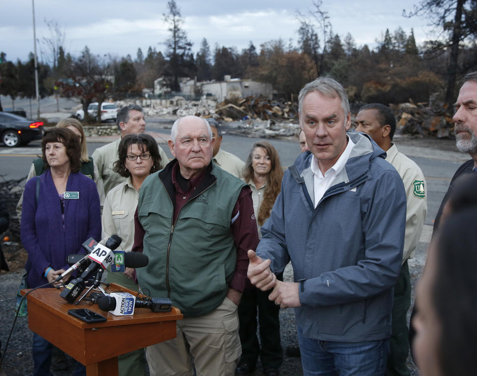 Interior Secretary Ryan Zinke, right, answers a reporter’s question after touring fire-ravaged Paradise, Calif., with Agriculture Secretary Sonny Perdue, center, on Monday. (Photo: Rich Pedroncelli/AP)