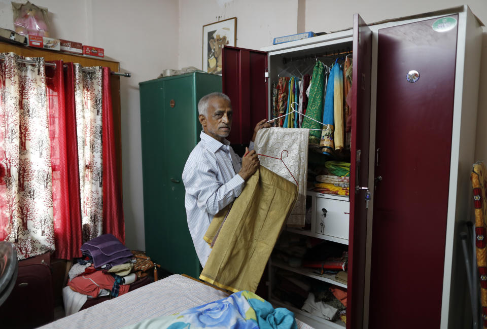 Radha Gobindo Pramanik arranges the saris of his wife, days after she died of the coronavirus, in Lucknow, India, Friday June 4, 2021. Within days, Pramanik's wife, his daughter and his unborn grandchild were among the tens of thousands killed as the coronavirus ravaged the country in April and May. As India emerges from its darkest days of the pandemic, families across the country are grieving all that they’ve lost and are left wondering if more could have been done to avoid this tragedy. (AP Photo/Rajesh Kumar Singh)