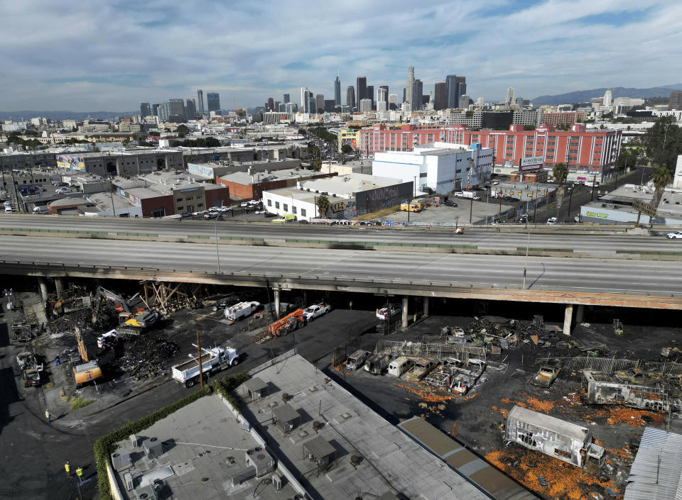 The damaged area of a fire on Lawrence Street shown in a portion of the Interstate 10 freeway in Los Angeles, between Alameda Street and Santa Fe Avenue on Monday, Nov. 13, 2023. A large fire broke out under the Interstate 10 Saturday after midnight, fully engulfing multiple pallets, vehicles, and trailers and causing extensive damage to the freeway. (Dean Musgrove/The Orange County Register via AP)