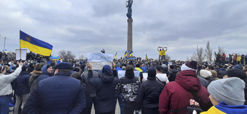 People wave Ukrainian flags during a rally against the Russian occupation in Kherson, Ukraine, Saturday, March 5, 2022. Ever since Russian forces took the southern Ukrainian city of Kherson in early March, residents sensed the occupiers had a special plan for their town. Now, amid a crescendo of warnings from Ukraine that Russia plans to stage a sham referendum to transform the territory into a pro-Moscow "people's republic," it appears locals guessed right. (AP Photo/Olexandr Chornyi)