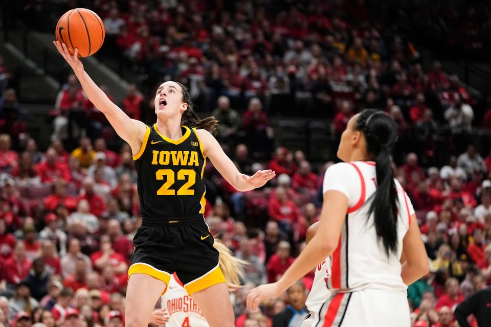 Jan 21, 2024; Columbus, Ohio, USA; Iowa Hawkeyes guard Caitlin Clark (22) makes a layup in front of Ohio State Buckeyes guard Celeste Taylor (12) during the NCAA women’s basketball game at Value City Arena. Adam Cairns/Columbus Dispatch-USA TODAY NETWORK