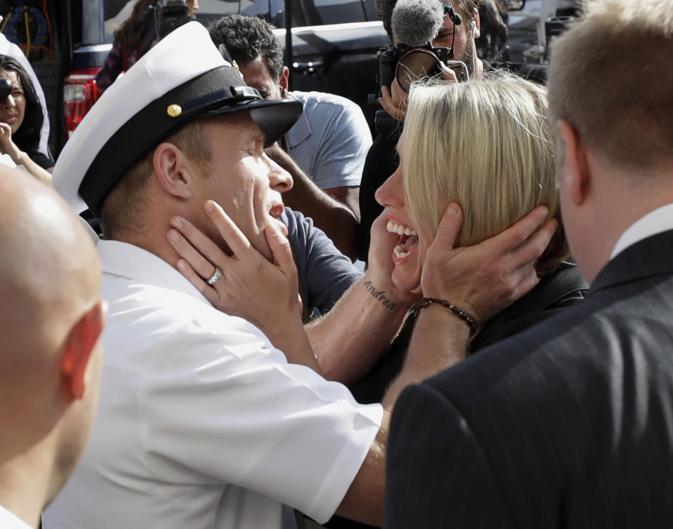 Navy Special Operations Chief Edward Gallagher, left, hugs his wife, Andrea Gallagher after leaving a military court on Naval Base San Diego, Tuesday, July 2, 2019, in San Diego. A military jury acquitted the decorated Navy SEAL Tuesday of murder in the killing of a wounded Islamic State captive under his care in Iraq in 2017. (AP Photo/Gregory Bull)