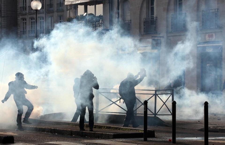 Demonstrators clash with French riot police during a demonstration in Nantes, Saturday Feb. 22, 2014, as part of a protest against a project to build an international airport, in Notre Dame des Landes, near Nantes. The project was decided in 2010 and the international airport should open by 2017. (AP Photo / Laetitia Notarianni)
