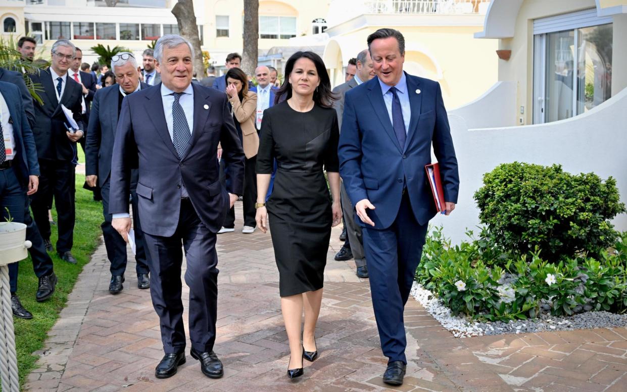 Italian Foreign Minister Antonio Tajani (left) walks with German Foreign Minister Annalena Baerbock and Lord Cameron