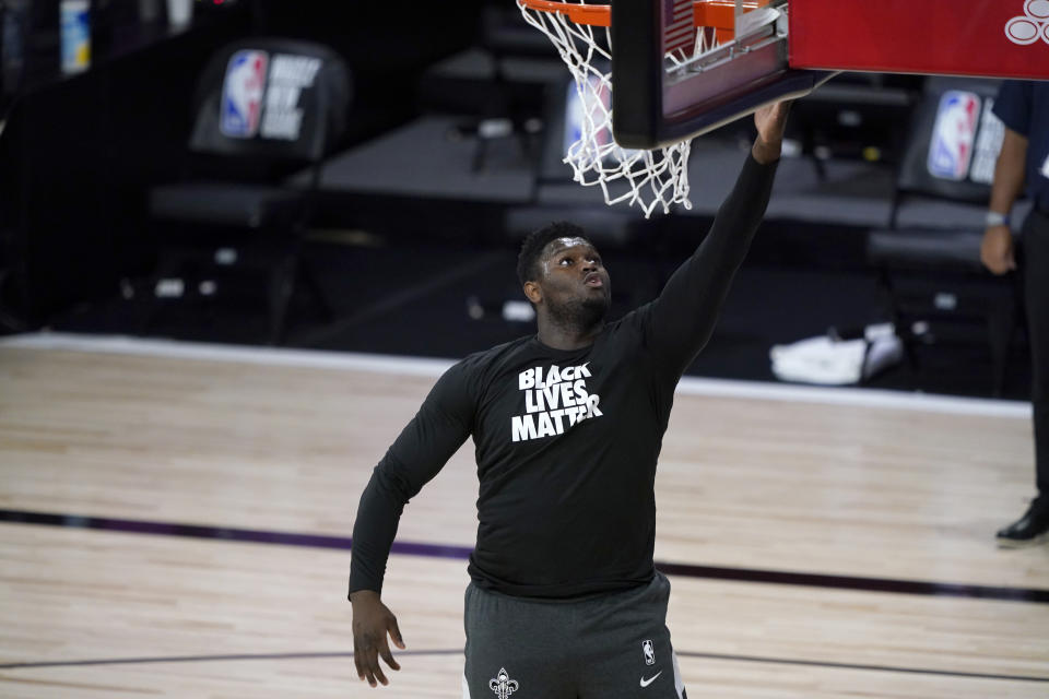 LAKE BUENA VISTA, FLORIDA - JULY 30:  Zion Williamson of the New Orleans Pelicans wears a Black Lives Matter shirt as he is introduced before the start of an NBA basketball game against the Utah Jazz  at HP Field House at ESPN Wide World Of Sports Complex on July 30, 2020 in Reunion, Florida. NOTE TO USER: User expressly acknowledges and agrees that, by downloading and or using this photograph, User is consenting to the terms and conditions of the Getty Images License Agreement. (Photo by Ashley Landis-Pool/Getty Images)