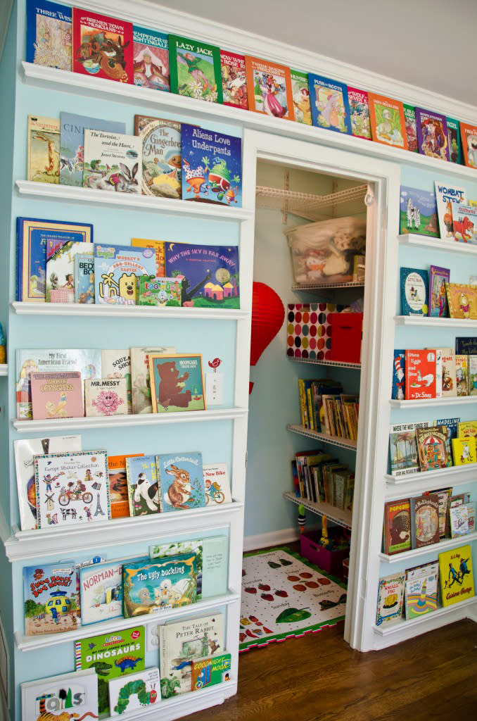 This photo provided by ProjectNursery.com shows a book wall as part of a kids' homework hub that can include a reading nook too. Create a comfortable reading nook on the floor with beanbags. Then mount floating shelves from floor to ceiling and display books with the covers facing out to entice young readers. (AP Photo/ProjectNursery.com)
