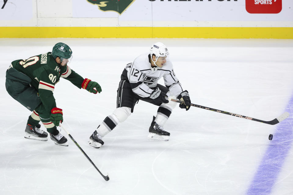 Los Angeles Kings left wing Trevor Moore, right, skates with the puck while Minnesota Wild center Marcus Johansson (90) defends during the third period of an NHL hockey game Thursday, Oct. 19, 2023, in St. Paul, Minn. (AP Photo/Matt Krohn)