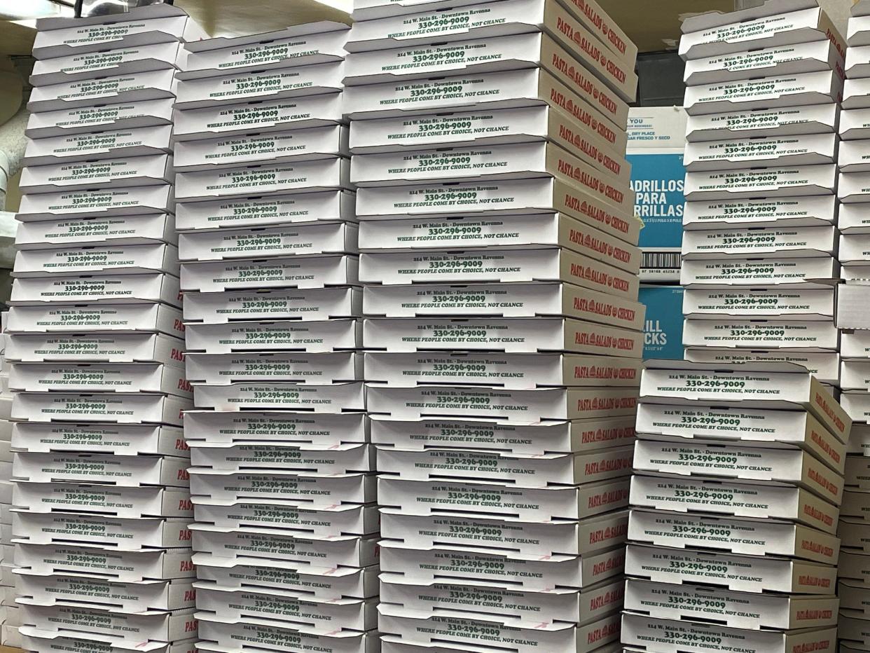 Stacks of pizza boxes inside of Guido's in Ravenna.