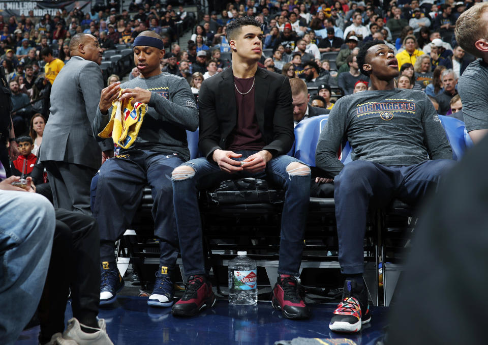 Denver Nuggets guard Isaiah Thomas, left, sits on the bench with injured rookie forward Michael Porter Jr. and forward Jarred Vanderbilt during the first half of the team's NBA basketball game against the Dallas Mavericks on Thursday, March 14, 2019, in Denver. (AP Photo/David Zalubowski)