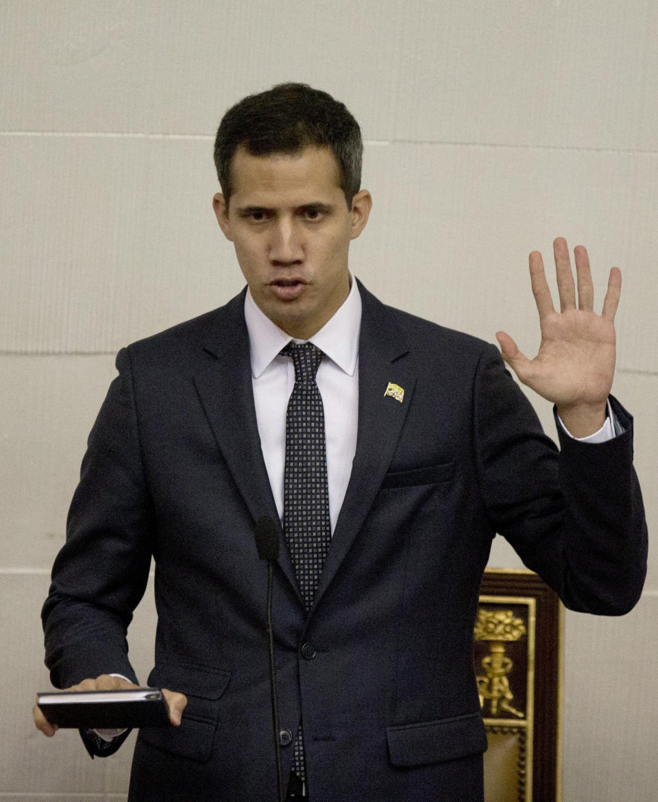 Venezuelan lawmaker Juan Guaido swears in as President of the National Assembly in Caracas, Venezuela, Saturday, Jan. 5, 2019. Venezuela's opposition-controlled congress holds its first session of the year under new leadership of Juan Guaido that is promising a more frontal assault on President Nicolas Maduro as he prepares to start a second term widely condemned as illegitimate. (AP Photo/Fernando Llano)
