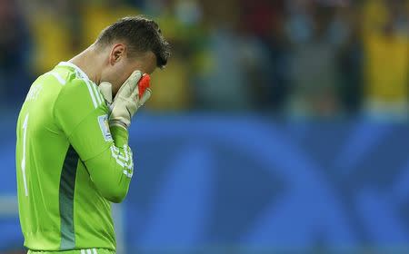 Russia's Igor Akinfeev reacts to conceding a goal to South Korea's Lee Keun-ho. REUTERS/Eddie Keogh