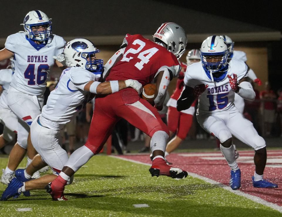 Fishers Tigers running back Khobie Martin (24) struggles in to the end zone during the annual Mudsock Game between rivals Hamilton Southeastern Royals and Fishers Tigers on Friday, Sept. 8, 2023 at Fishers High School in Fishers. Hamilton Southeastern Royals took home the trophy after a 35-34 overtime victory.