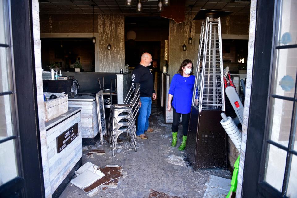 Franchise co-owners Dell and Peggy Hoard look over the aftermath of the  Jan. 19 fire that severely damaged their Grumpy's Restaurant in Middleburg.