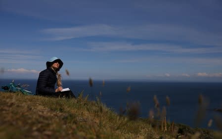 Scientist Dr Melanie Windridge takes part in a 'Cloud sketching' workshop during the Cloud Appreciation Society gathering on Lundy