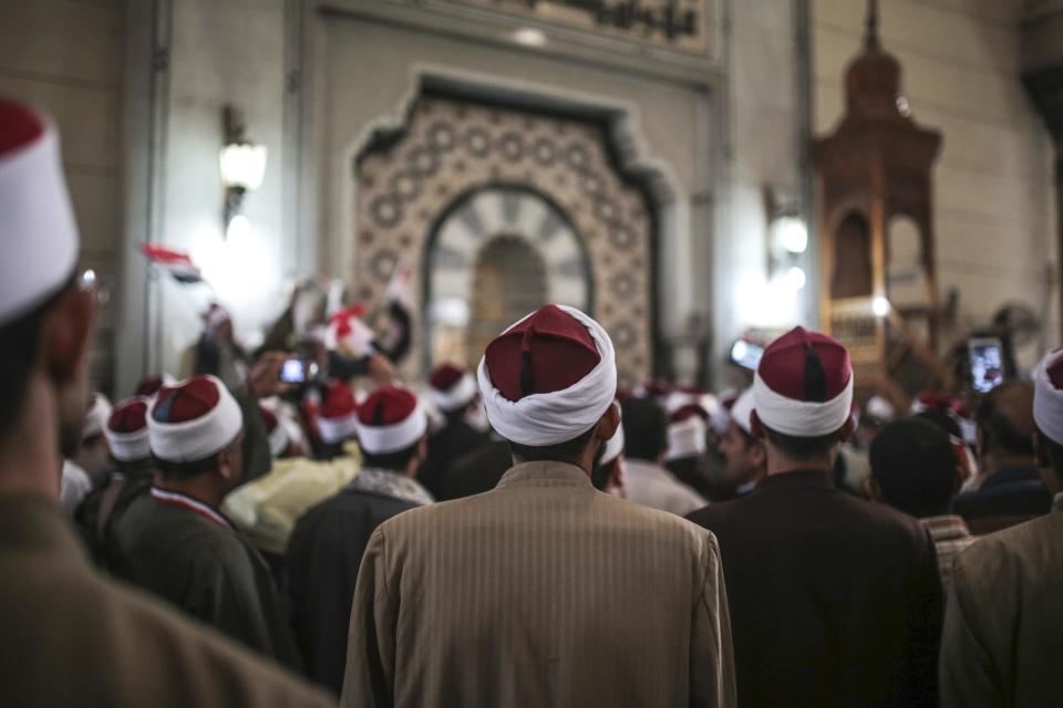 FILE - In this Tuesday, Feb. 3, 2015 file photo, Egyptian clerics from Al-Azhar institution rally to denounce terrorism and show solidarity with the Egyptian government and security forces at a mosque in central, Cairo. Egypt’s top Islamic authority has rejected the president’s suggestion for legislation that would invalidate the practice of men verbally divorcing their wives. Al-Azhar’s Council of Grand Clerics says verbal divorce, when appropriately declared by husbands with sound minds, has been an undisputed practice since the days of the 7th century Prophet Muhammad. (AP Photo/Mosa'ab Elshamy, File)