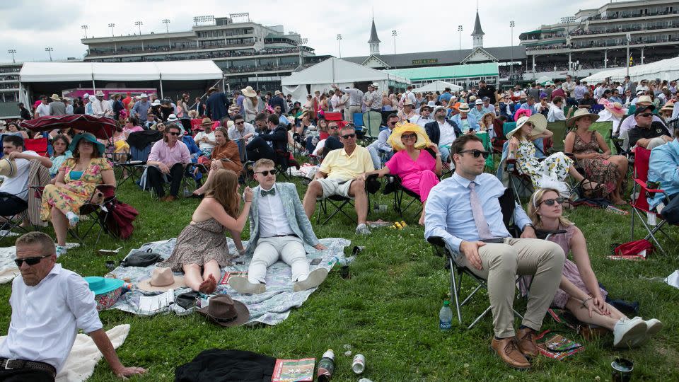 Fans watch the race on a screen in the field on the day of the 149th Derby on May 6, 2023. About 150,000 people went to see last year's Derby. - Amira Karaoud/Reuters