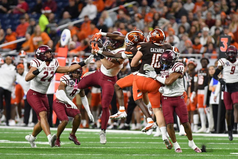Dec 26, 2022; Detroit, Michigan, USA; New Mexico State linebackerTrevor Brohard (80) intercepts a pass intended for Bowling Green wide receiver Odieu Hiliare (1) in the first quarter in the 2022 Quick Lane Bowl at Ford Field.