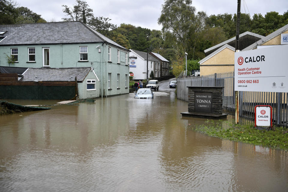 A car is stranded in floodwater where an amber weather warning is in force across the region, in Tonna near Aberdulais, Neath, in South Wales, Saturday, Oct. 13.2018. (Ben Birchall/PA via AP)