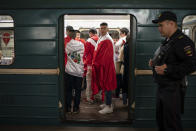 <p>Soccer fans ride in the metro near the Luzhniki stadium before the group A match between Russia and Saudi Arabia which opens the 2018 soccer World Cup in Moscow, Russia, Thursday, June 14, 2018. (AP Photo/Felipe Dana) </p>