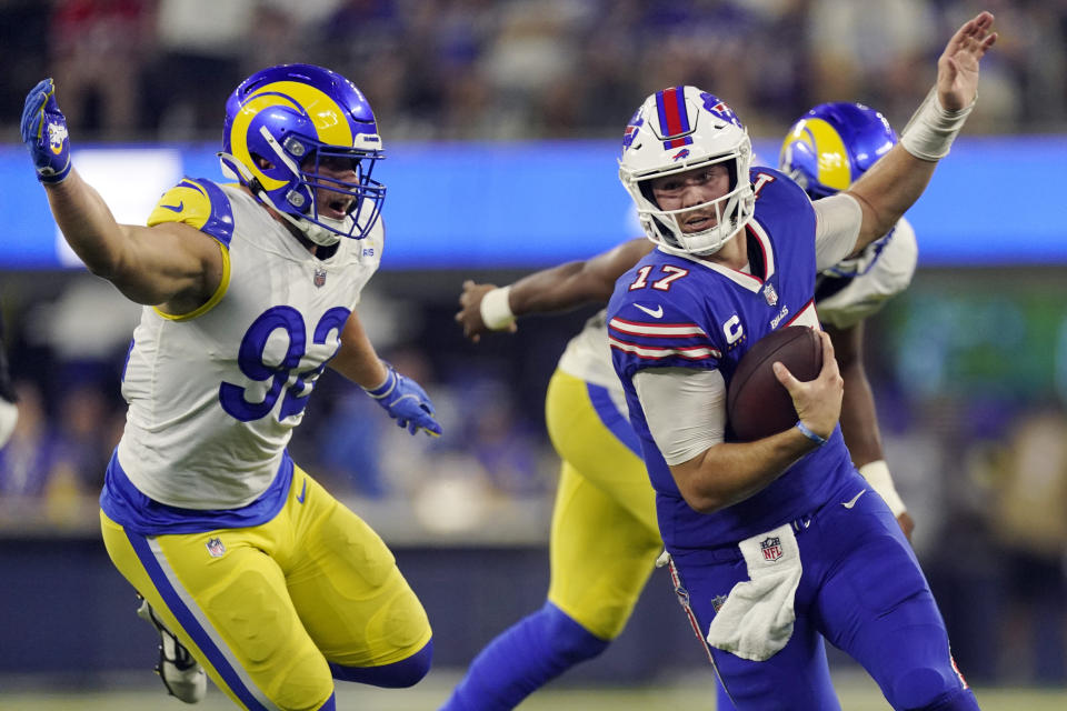 Buffalo Bills quarterback Josh Allen, right, is chased by Los Angeles Rams defensive tackle Jonah Williams (92) during the second half of an NFL football game Thursday, Sept. 8, 2022, in Inglewood, Calif. (AP Photo/Mark J. Terrill)