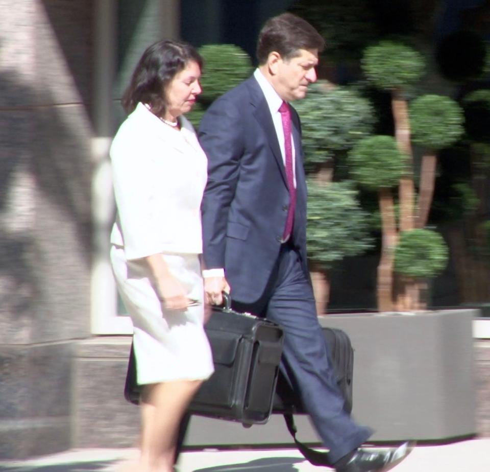 State Auditor Kathy McGuiness (left) walks down N. Market St. with Steve Wood, her attorney.