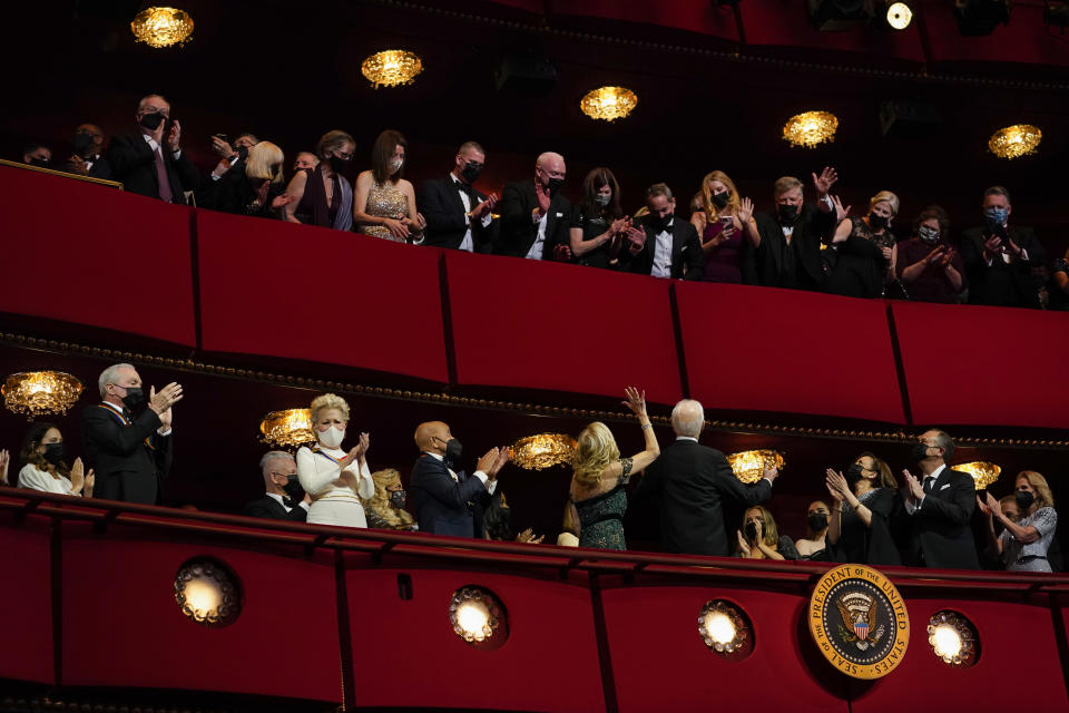 President Joe Biden and first lady Jill Biden turn to wave to the upper balcony as they arrive for the 44th Kennedy Center Honors at the John F. Kennedy Center for the Performing Arts in Washington, Sunday, Dec. 5, 2021. Also seen are Vice President Kamala Harris, third from right, and second gentleman Doug Emhoff, second from right, 2021 Kennedy Center honorees Motown Records creator Berry Gordy, third from left, "Saturday Night Live" mastermind Lorne Michaels, left, and actress-singer Bette Midler. (AP Photo/Carolyn Kaster)