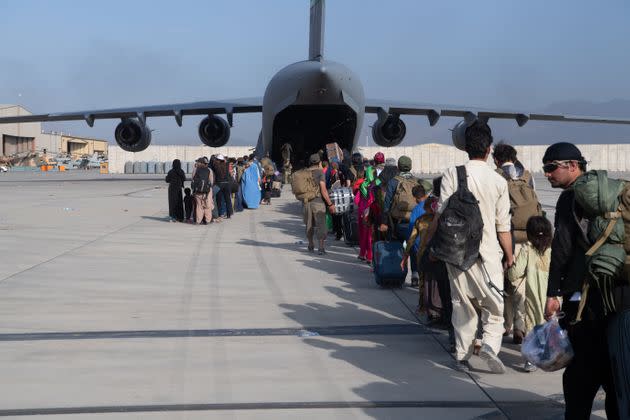 U.S. Air Force loadmasters and pilots assigned to the 816th Expeditionary Airlift Squadron put passengers aboard an Air Force C-17 Globemaster III in support of the Afghanistan evacuation at Hamid Karzai International Airport on Aug. 24, 2021, in Kabul. (Photo: Master Sgt. Donald R. Allen/U.S. Air Forces Europe-Africa via Getty Images)