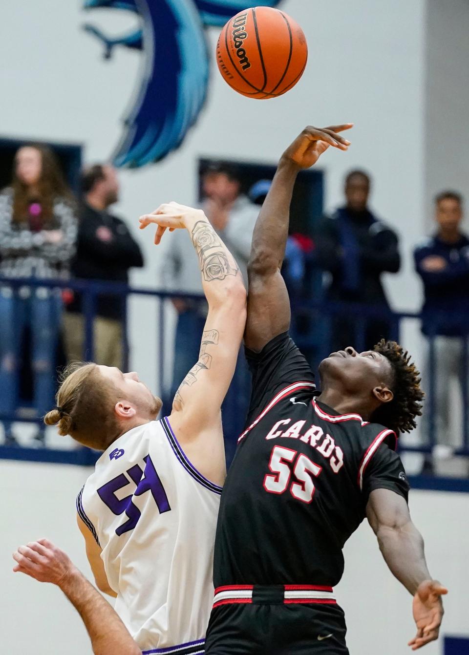 Ben Davis Giants center Zane Doughty (54) and Southport Cardinals Nickens Lemba (55) reach for the ball during tip-off Wednesday, March 1, 2023 at Perry Meridian High School in Indianapolis. The Ben Davis Giants defeated the Southport Cardinals, 62-46.