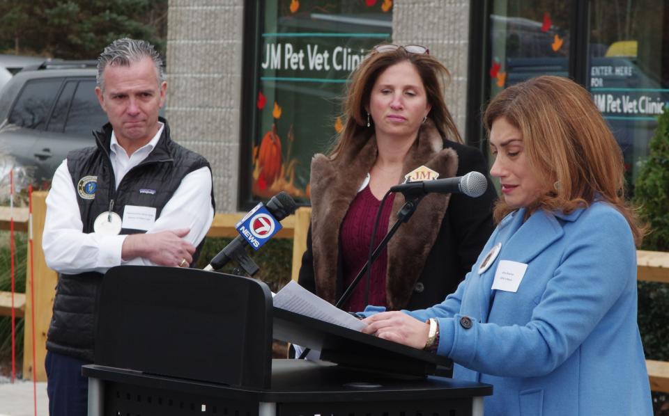 Wed., Nov. 17, 2021 -- Amy Baxter, owner of the dog Ollie, who was mauled by another dog at a pet center he was staying at and later died, gets a little emotional while describing the struggle Ollie went through before succumbing to his injuries. Baxter used that experience to pursue legislation to prevent anyone else from having to go through the same trauma, and she had the support of a great many people in pursuing the bill named "Ollie's Law" after her cherished puppy was attacked. Looking on are Rep. Brian Ashe who sponsored the bill, and Jeni Mather, owner of JM's Pet Resort in Brockton.