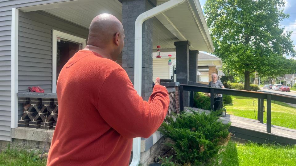 DaJuan Thrasher spoke with more than a dozen neighbors Tuesday, May 21, 2024 about his son in and around the area where he was shot and killed the night before.