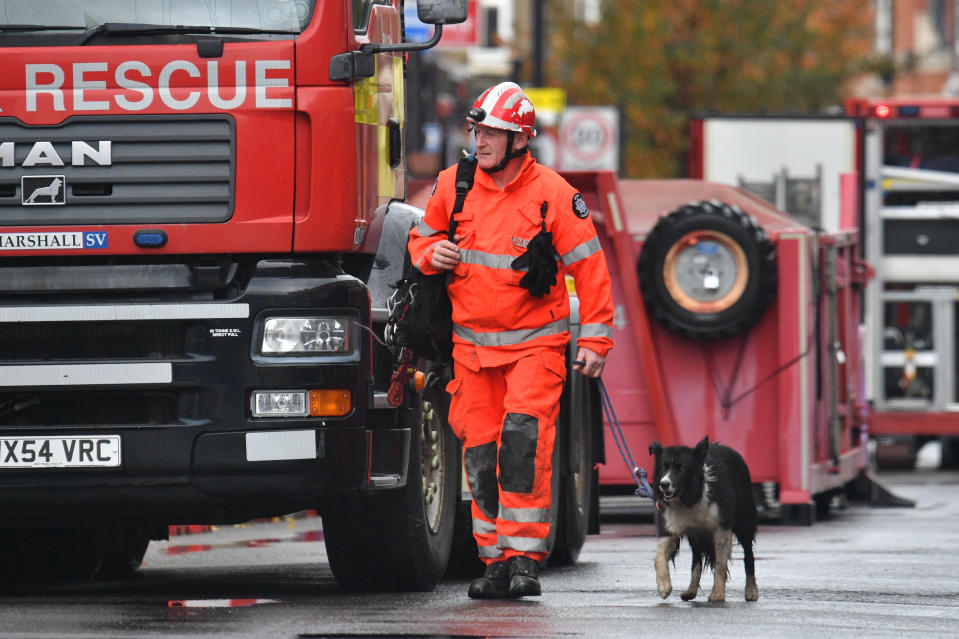 Emergency services arrive with a dog at the scene of a suspected gas explosion on King Street in Ealing, west London. Rescuers are involved in a "complex" search for anyone who may still be inside the collapsed building.