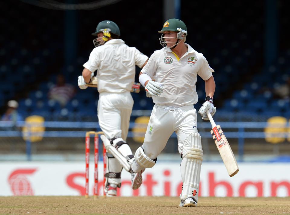 Australian batsmen David Warner (R) and Ed Cowan run during the fourth day of the second-of-three Test matches between Australia and West Indies April 18, 2012 at Queen's Park Oval in Port of Spain, Trinidad.