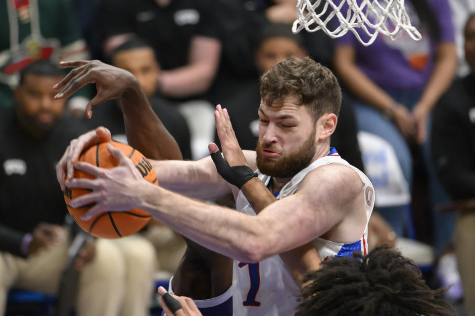 Kansas center Hunter Dickinson battles for a rebound against TCU during the first half of an NCAA college basketball game in Lawrence, Kan., Saturday, Jan. 6, 2024. (AP Photo/Reed Hoffmann)