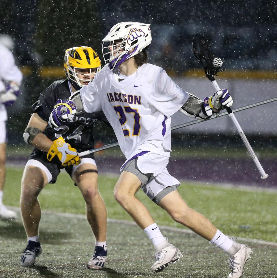 Thomas Chevalier, 27, of Jackson looks to get around Connor Grace, 34, of St. Ignatius during their game at Jackson on Wednesday, April 6, 2022.