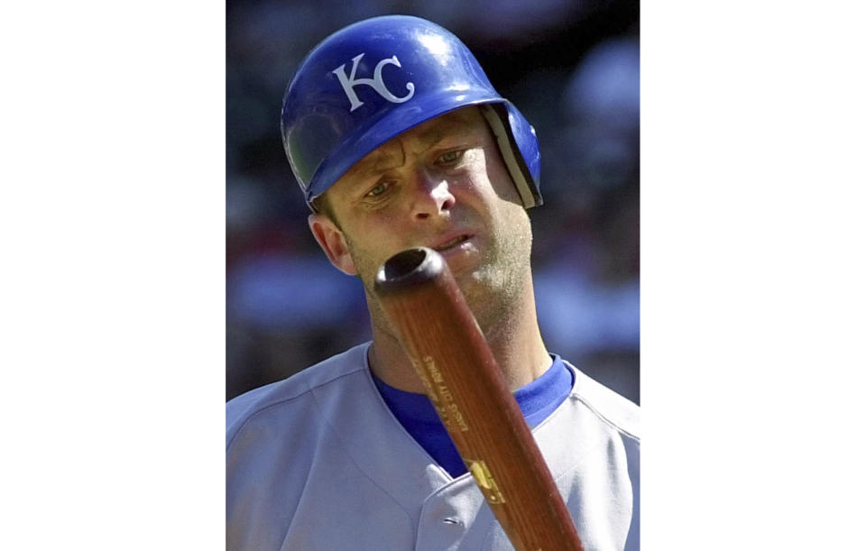 FILE - Kansas City Royals batter Dave McCarty inspects his bat after hitting a foul ball during the seventh inning against the Texas Rangers in a baseball game in Arlington, Texas, May 31, 2001. McCarty, a member of the Boston Red Sox championship team in 2004 who played with seven MLB teams in an 11-year career, has died. He was 54. The Red Sox announced McCarty's death in a statement, saying the former first baseman and outfielder died Friday, April 19, 2024, after suffering a cardiac event in Oakland, Calif. (AP Photo/Bill Janscha, File)