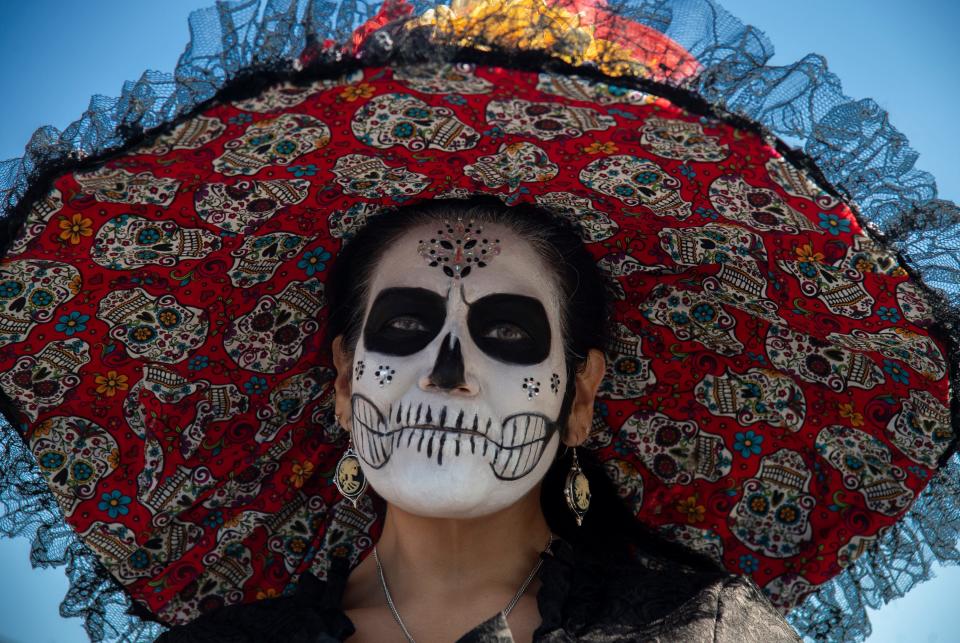 Marie Williams competed in the Catrina pageant at the Mexican Heritage Center's 4th annual De Los Muertos Street Fiesta in downtown Stockton on Oct. 28, 2023. The event, at the intersection of Market and Sutter streets, celebrates Mexican culture and remembers past ancestors. Altars, or offends were on display as well as the car show. A Catrina pageant accompanied musical acts as well as food and crafts vendors.