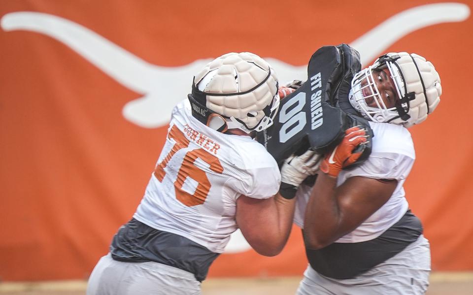 Offensive linemen Hayden Conner, left, and Christian Jones go through drills March 21 at Royal-Memorial Stadium. Increased depth on the offensive line and few injuries have the Longhorns on pace for a traditional spring game.