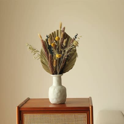 A naturally dried bouquet featuring autumnal colors that'll be a welcome part of your decor