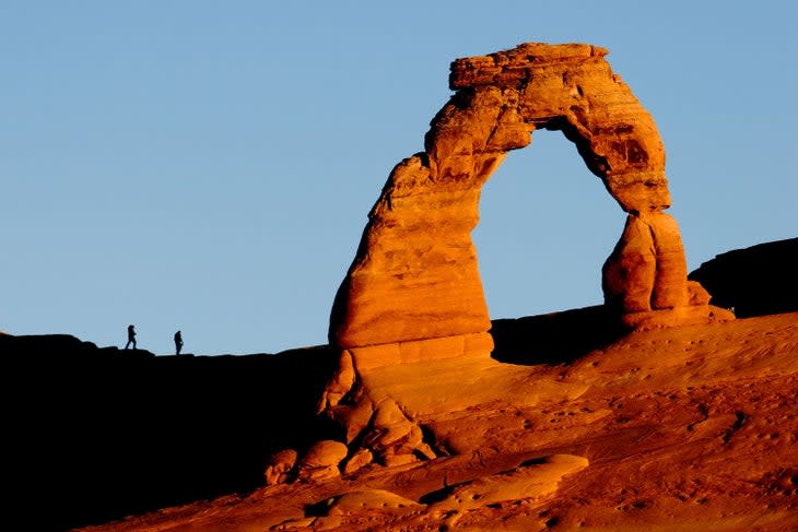 Delicate Arch lights up at sunrise in Arches National Park