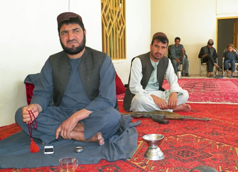 Uruzgan police commander for the Barakzai tribe, Shah Mohammad (L), speaks during an interview with AFP at his house in Tarin Kot, on April 30, 2016 The decision to sack an Afghan strongman accused of deliberately handing over parts of a crucial southern highway to the Taliban has laid bare power struggles and tribal feuds within police ranks, worsening insecurity. Dozens of police checkpoints on the 160 kilometre (100 mile) highway connecting the provincial capitals of Tarin Kot, in Uruzgan, and Kandahar last week fell under Taliban control, raising security alarms