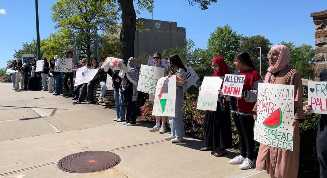 Students held signs Monday on the campus of the University of Missouri - Kansas City as college protests denouncing the war in Gaza spread across the country.