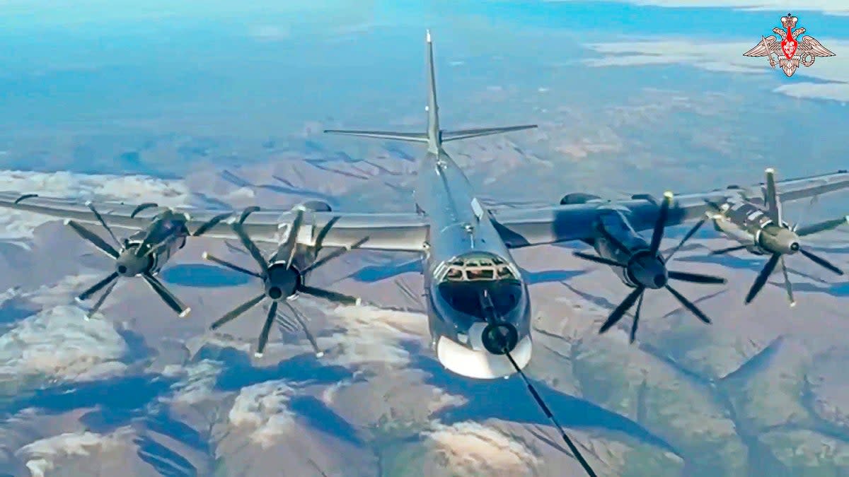 A Tu-95 strategic bomber of the Russian air force is refuelled in the air during a joint Russia-China air patrol  (Russian Defense Ministry Press Service)