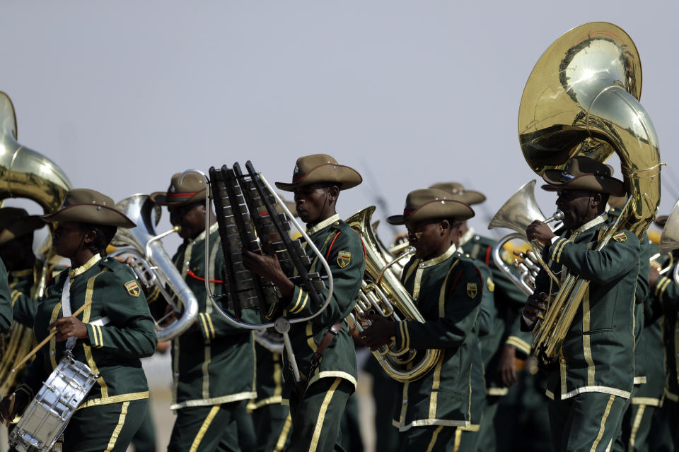 A guard of honour band march during a ceremony for late former President Robert Mugabe's arrival at the Robert Gabriel Mugabe International Airport in HarareHarare, Zimbabwe, Wednesday, Sept. 11, 2019. (AP Photo/Themba Hadebe)