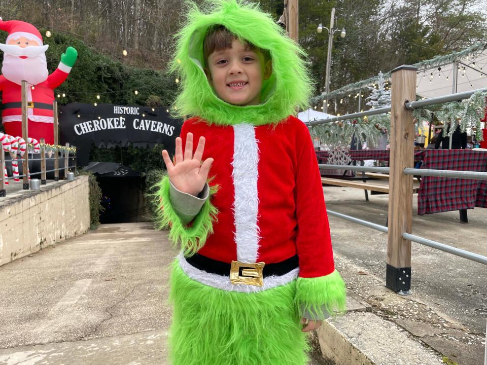 Tayden Price, 7, channeling his inner Grinch, volunteers to greet people at Christmas in the Cave at the Historical Cherokee Caverns Sunday, Dec. 4, 2022
