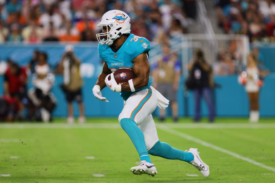 Aug 17, 2024; Miami Gardens, Florida, USA; Miami Dolphins running back Chris Brooks (35) runs with the football against the Washington Commanders during the second quarter of a preseason game at Hard Rock Stadium. Mandatory Credit: Sam Navarro-USA TODAY Sports