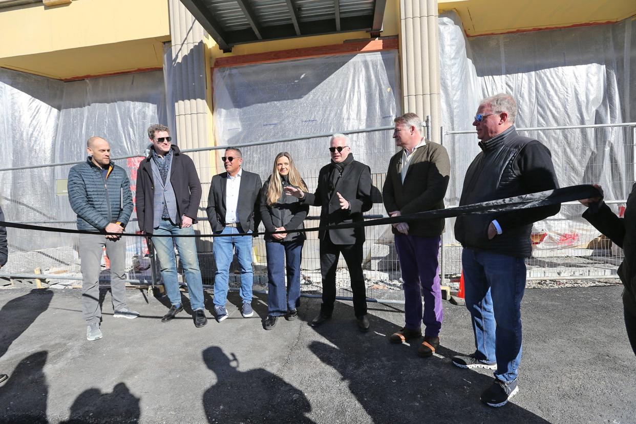 Scott Rome of Brick & Barn | Compass, the leasing agency for The Howard, says a few words before the official ribbon cutting in Rochester Wednesday, Feb. 7, 2024. From left are David Groen of Groen Construction, developer Paul Grant, Joey Giordano of Brick & Barn, residential leasing agent Maggie Getman, developer Doug Grant and commercial space leasing agent Bob Marchewka.