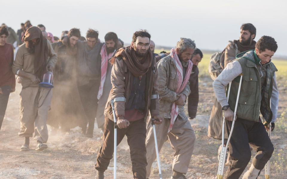 Men, likely fighters, who have fled from Isil's last remaining territory in Syria, in March 2019 - Sam Tarling for The Telegraph