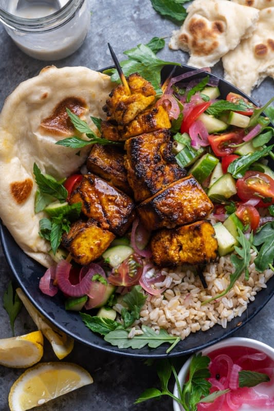 <p>Wandering Chickpea</p><p>Tofu skewers marinated in Middle Eastern Spices and grilled until crispy, served alongside warm pita, fresh tomatoes, cucumbers, and drizzled in a quick tahini yogurt sauce. Vegan, easy to make and so flavorful.</p><p><strong>Get the recipe: <a href="https://wanderingchickpea.com/2021/08/15/grilled-tofu-shawarma-bowls/" rel="nofollow noopener" target="_blank" data-ylk="slk:Grilled Tofu Shawarma Bowls;elm:context_link;itc:0;sec:content-canvas" class="link "><em>Grilled Tofu Shawarma Bowls</em></a></strong></p>